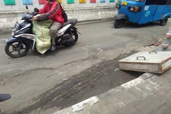57156 small jalan rusak di tepi flyover pramuka tak kunjung diperbaiki